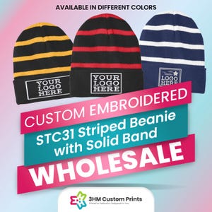 May include: Three striped beanies in black, red, and blue with a white band. Each beanie has a white rectangle with the text "YOUR LOGO HERE" embroidered on it. The beanies are available in different colors and are custom embroidered. The text "CUSTOM EMBROIDERED STC31 Striped Beanie with Solid Band WHOLESALE" is displayed on the image. The image also includes the logo "3HM Custom Prints Printed to Perfection, Designed for You."