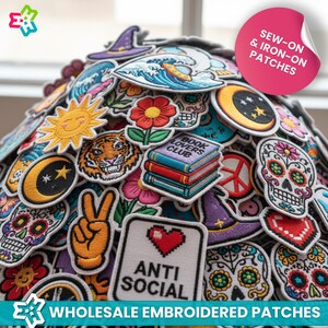 May include: A collection of embroidered patches featuring various designs, including a smiling sun, tiger, crescent moon, peace sign, and sugar skull. The patches are in various colors and shapes, with the text "ANTI SOCIAL" and "BOOK LOVERS CLUB". The image also includes the text "SEW-ON & IRON-ON PATCHES" and "WHOLESALE EMBROIDERED PATCHES".
