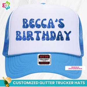 May include: A white trucker hat with a blue mesh back. The front of the hat has blue glitter letters that say "Becca's Birthday".