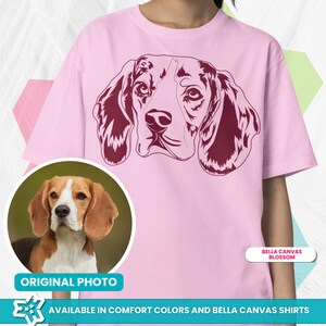 May include: A pink t-shirt with a maroon silhouette of a Beagle dog's head. The original photo of the Beagle is shown in a circle on the left side of the image. The text "Bella Canvas Blossom" is in a white rectangle on the right side of the image. The text "ORIGINAL PHOTO" is below the photo of the Beagle. The text "AVAILABLE IN COMFORT COLORS AND BELLA CANVAS SHIRTS" is at the bottom of the image.