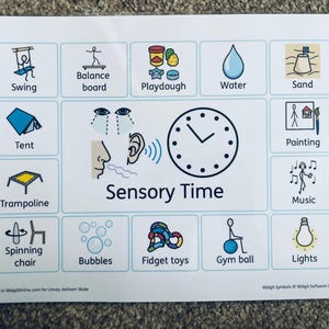 May include: A white printed sheet featuring activity icons such as a swing, balance board, and trampoline. The sheet is labelled "Sensory Time" and includes icons for water, sand, and music. The sheet also includes the text "Created in WidgitOnline.com for Linsey Jackson-Skate."