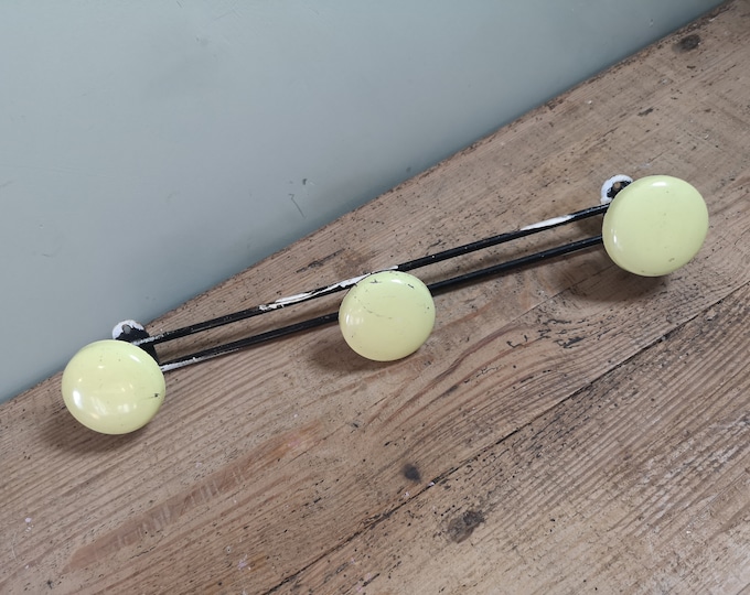 Vintage French yellow enamel and metal coat knobs wall rack