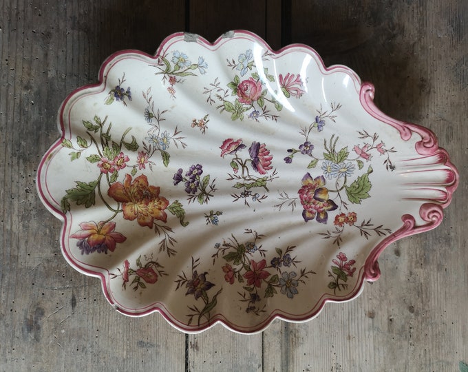 Pretty antique shell shaped terre de fer dish with hand coloured floral decoration made by Longchamp