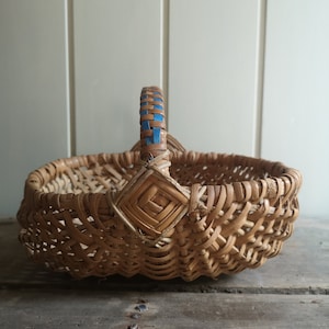 Vintage French woven wicker petite harvest basket with blue handle detail