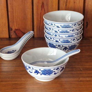 Vintage Chinese rice bowls with spoons. Blue and white floral design.