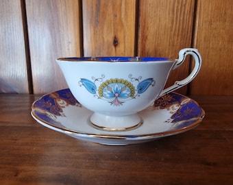 Vintage Paragon Fine Bone China tea cup and saucer. Cobalt blue with gold detailing. Excellent condition.