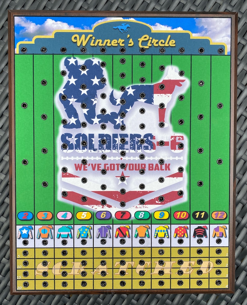 May include: A wooden game board with a green field and a yellow track. The board features a patriotic design with a soldier and a dog, and the text "SOLDIERS-6 WE'VE GOT YOUR BACK". The board has a grid of holes and a row of numbered spaces at the bottom.