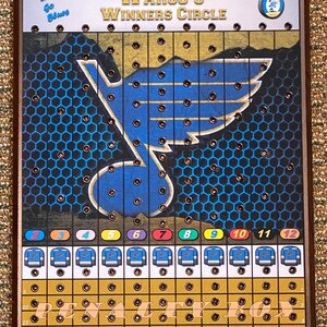 May include: A wooden game board with a blue and gold design featuring a hockey team logo. The board has a grid of holes and a section labeled "Penalty Box".