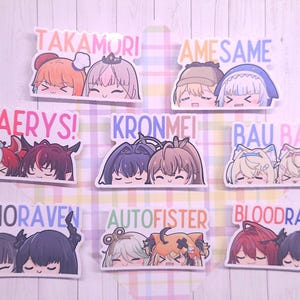 May include: A collection of colorful stickers featuring anime-style illustrations of pairs of characters. Each sticker has a unique name written above the characters, such as "TAKAMORI" and "AMESAME". The stickers have a glossy finish.