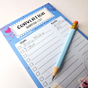 May include: A blue checklist with a pencil on top. The checklist is titled "Convention Shopping List" and has the convention name "Anime Con". The checklist includes items like "Bunny Sticker" and "T-Shirt".