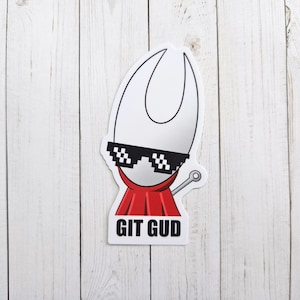 May include: A white sticker with a cartoon character wearing sunglasses and a red cape. The character has the text "GIT GUD" below it.