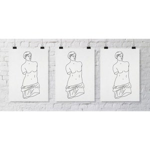 Puede incluir: Tres dibujos en blanco y negro de la estatua de Venus de Milo sobre papel blanco, cada uno enmarcado con un passe-partout blanco y colgado en una pared de ladrillo blanco.