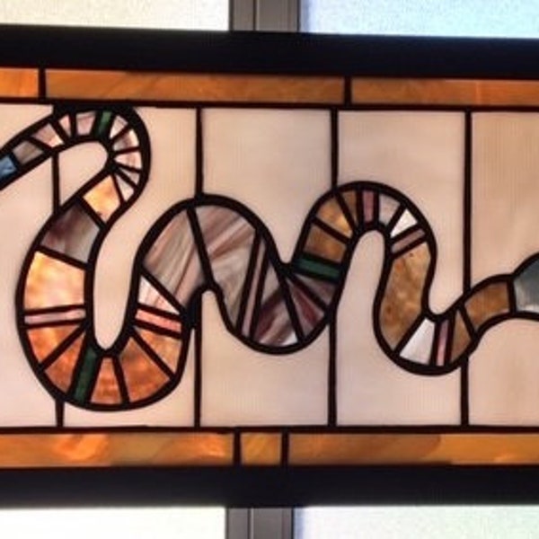 Stained glass snake window panel. Framed and ready to hang. Beautiful desert landscape colors.