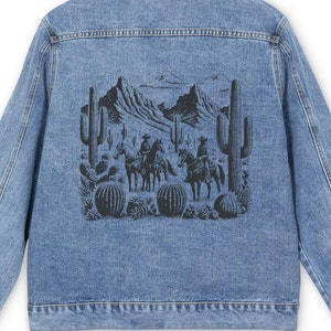 May include: A blue denim jacket with a black and white graphic print of a desert scene with cacti and cowboys riding horses on the back.