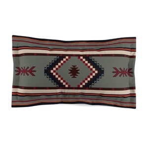 May include: A decorative pillow with a geometric pattern in shades of red, blue, white, and brown on a gray background.