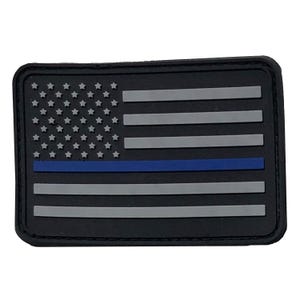 May include: A rectangular patch featuring a stylized American flag design in black, grey, and blue. The background is black with raised grey stars and horizontal stripes, and a single horizontal blue stripe positioned below the stars.