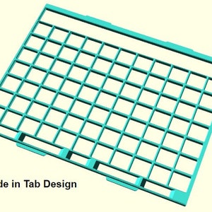 May include: A turquoise blue plastic grid with tabs on the bottom edge. The grid has a slide-in tab design. "Slide in Tab Design" is written below the grid.