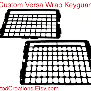 May include: Two black custom Versa Wrap keyguards are displayed against a white background. The keyguards have a grid-like pattern of square openings. The text "Custom Versa Wrap Keyguards" is at the top, and "AdaptedCreations.Etsy.com" is at the bottom.