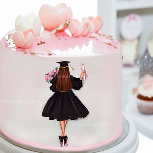 May include: A pink and white cake decorated with pink sugar flowers and a fondant topper of a woman in a black graduation gown holding a diploma. The cake is on a white cake stand.