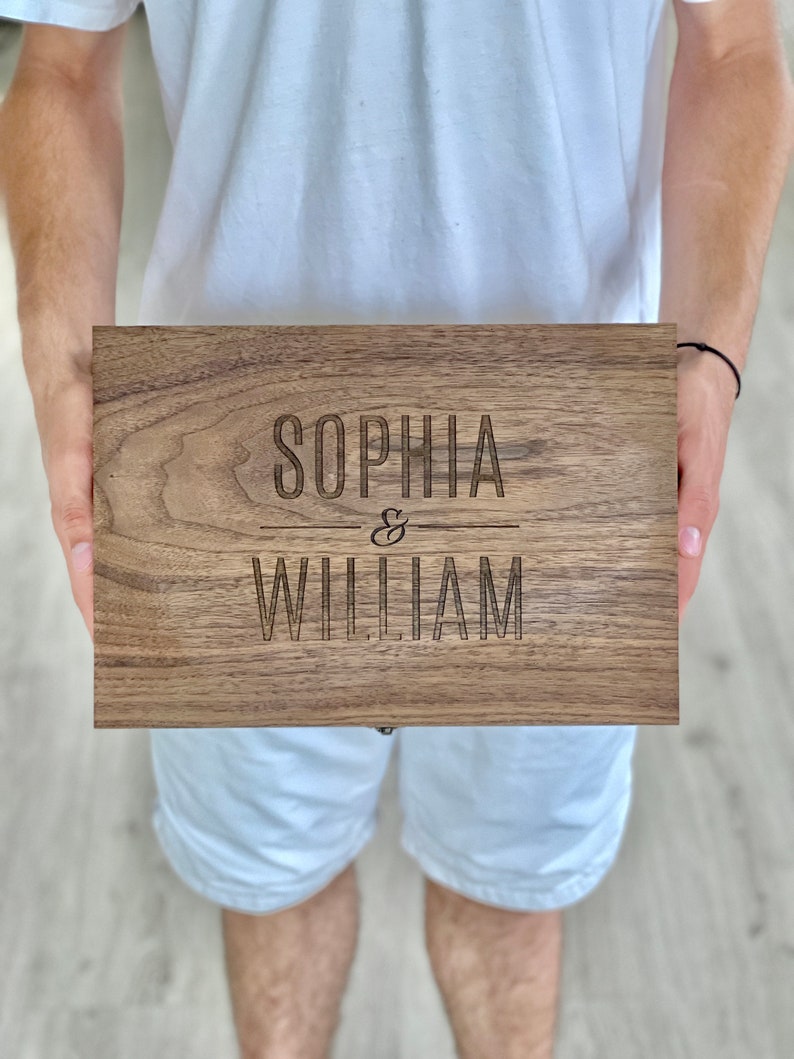 K&ouml;nnte beinhalten: Eine Holzkiste mit den Namen "Sophia & William" auf der Oberseite eingraviert.