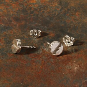 “Slot” ear studs in cylinder head shape. The male ear jewelry for craftsmen or screw manufacturers in solid silver