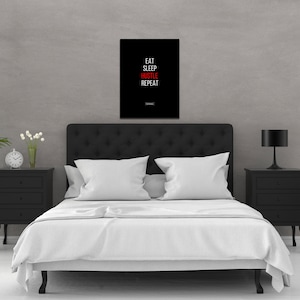 May include: Black and white motivational poster with the text "Eat Sleep Hustle Repeat" in white letters with the word "Hustle" in red.