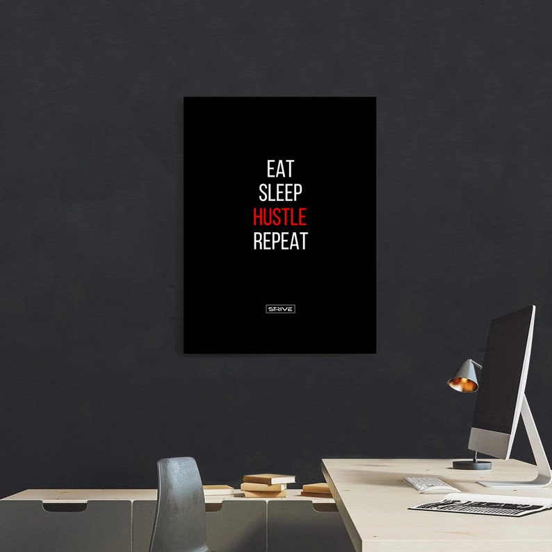 May include: Black and white motivational poster with the text "Eat Sleep Hustle Repeat" in white with the word "Hustle" in red. The text "STRIVE" is in red at the bottom of the poster.