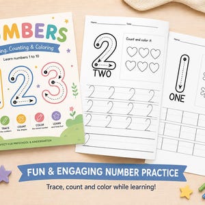 Pode incluir: Um caderno de exercícios para crianças sobre números com atividades de traçado, contagem e colorir, ilustrado com um leão na capa. O conjunto inclui páginas imprimíveis com exercícios, incluindo o traçado do número dois com corações e o um com flores.