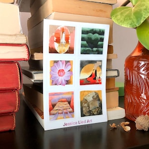 Puede incluir: Una impresión artística blanca con seis pinturas de acuarela. La obra de arte incluye imágenes de un cohete, un corazón, una flor, una figura, un paisaje y una roca. La impresión se titula "Jessica Lied Art."