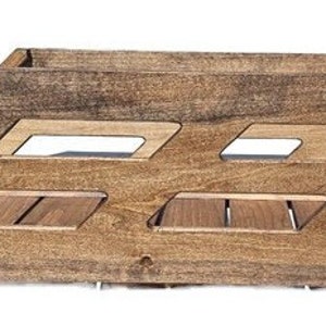 May include: A wooden storage crate with a natural brown finish. The crate has three open compartments with slatted bottoms.