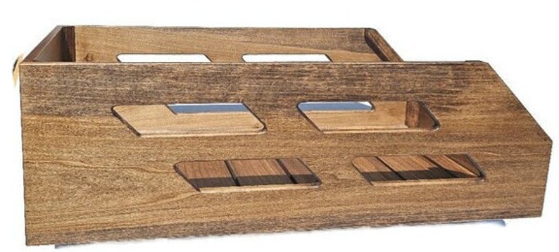 May include: A wooden storage crate with a dark brown stain. The crate has multiple open compartments and a slatted bottom.