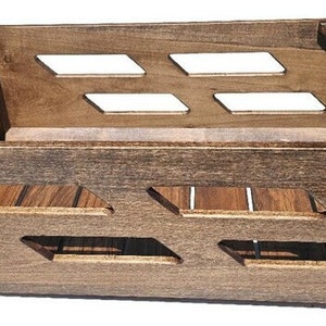 May include: A dark brown wooden storage crate with a slatted bottom and open sides. The crate has a unique design with cutouts on the front and sides.