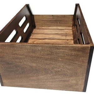 May include: A dark brown wooden storage crate with a slatted design on the front and sides. The crate is made of solid wood and has a natural finish.