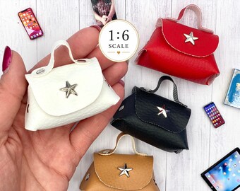 May include: Four miniature handbags in 1:6 scale, each featuring a single top handle, a fold-over flap, and a silver-toned star emblem. The bags are colored white, red, black, and tan, and each includes small silver-toned metal rivets on the sides.
