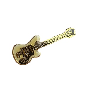 May include: A gold-colored guitar pin with a white body and black details. The pin is a novelty item for music lovers.