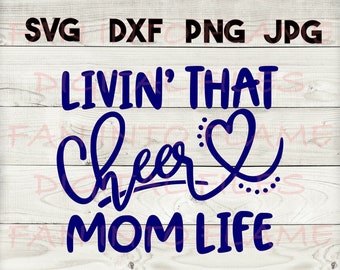 May include: Blue text on a wood background reads "Livin' That Cheer Mom Life" with a heart symbol.