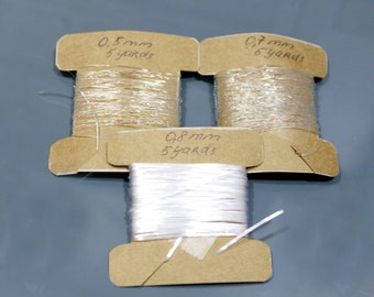 cortado a tamaño 0.5 / 0.7 / 0.8mm elástico blanco blanco transparente cuentas de hilo redondo plano cordón elástico Joyería Suministros de fabricación Cuerda de pulsera