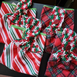 May include: Three red and green Christmas dish towels with crocheted trim. The towels have a candy cane stripe pattern, a plaid pattern, and a red and white stripe pattern.