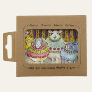May include: A brown cardboard package with a rectangular window displaying a microfiber lens cloth. The cloth features a colorful illustration of three sheep wearing sweaters. Text on the package reads "Glasses. Screens. Tablets. Camera" and "Soft & squidgy microfiber lens cloth."