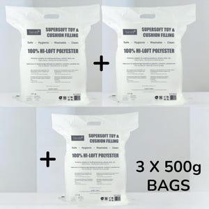May include: Three white bags of Trimits Supersoft Toy & Cushion Filling, each containing 500g of 100% Hi-Loft Polyester. The bags are labeled as safe, hygienic, washable, and clean, ideal for stuffing plushies, pillows, and more.