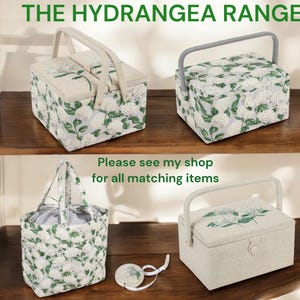 May include: Four fabric storage boxes with a floral pattern. The boxes are arranged on a wooden shelf. The text "The Hydrangea Range" is at the top of the image. The text "Please see my shop for all matching items" is in the middle of the image.