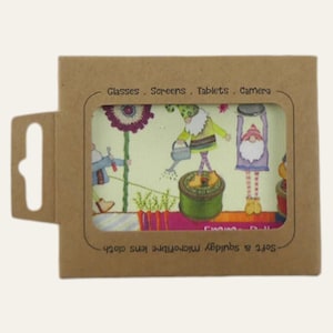 May include: A microfiber lens cloth with a whimsical garden gnome design, packaged in a brown cardboard sleeve. The cloth features colorful gnomes watering plants and the text "Glasses. Screens. Tablets. Camera."