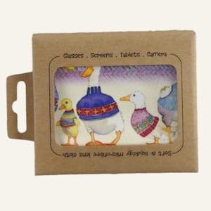 May include: A microfiber lens cloth in a cardboard box. The cloth features a watercolor illustration of ducks wearing sweaters. The box reads "Glasses. Screens. Tablets. Camera" and "Soft & squidgy microfiber lens cloth."