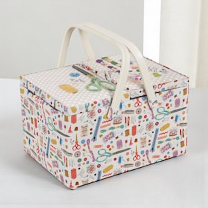 May include: A white sewing box with a white handle and a lid. The box is patterned with sewing tools, including scissors, spools of thread, and needles. The lid has a polka dot pattern.