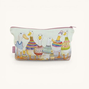 May include: A rectangular zipped pouch featuring a watercolour illustration of several white ducks wearing colourful patterned jumpers and hats. The background is a light cream colour, and a small pink fabric tag is visible on the left side.