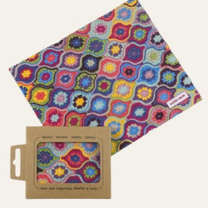 May include: A colorful microfiber lens cloth with a repeating floral pattern in shades of purple, blue, yellow, and green. The cloth is next to a cardboard box with a matching pattern and the text "Glasses, Screens, Tablets, Cameras". The brand name "Janie Crow" is visible.