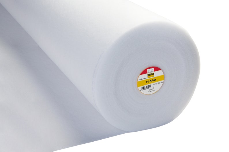 May include: A white roll of interfacing fabric with a yellow and red label that says "Vlieseline H 640".