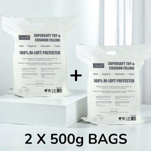 May include: Two white bags of Trimits Supersoft Toy & Cushion Filling, each with 100% Hi-Loft Polyester. The bags are labelled as safe, hygienic, washable, and clean. The text "2 X 500g BAGS" is displayed at the bottom.