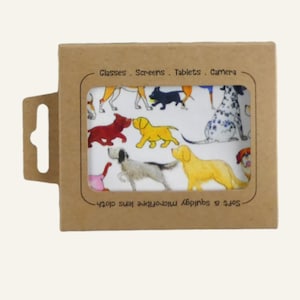 May include: A brown cardboard box with a window displaying a white microfiber lens cloth. The cloth features colorful illustrations of various dog breeds. Text on the box reads "Glasses. Screens. Tablets. Camera."
