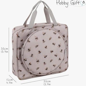 May include: A beige Hobby Gift sewing bag featuring a bee design. The bag is rectangular with a circular front compartment. Dimensions are 35cm wide, 35cm high, and 12cm deep. It has grey handles and the text "Hobby Gift".